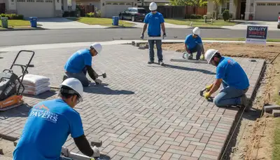 Technicians installing driveway pavers in Orange County, CA with precise base prep and leveling techniques